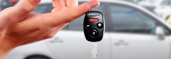 a woman holding the keys to her used car